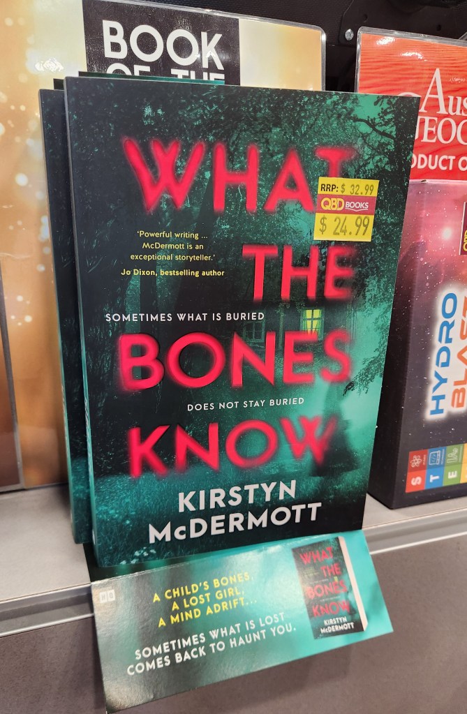 What the Bones Know on a counter display as QBD Book of the Month - Fiction.